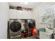 Laundry room with modern washer, dryer, utility sink and storage cabinets at 992 Yemassee Trl, Stone Mountain, GA 30083