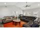 Comfortable living room featuring cozy sofas, ceiling fan, an orange rug and a bar at 992 Yemassee Trl, Stone Mountain, GA 30083