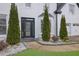 Close-up of the front entrance with decorative trees and a stylish glass door at 359 Bay Hill Ct, Lawrenceville, GA 30043