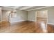 Expansive living room with gleaming hardwood floors, staircase, and dining room access at 1686 Niskey Lake Sw Rd, Atlanta, GA 30331