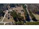 Picturesque aerial view of a country estate with lush greenery and a winding road at 5570 Bold Springs Rd, Dacula, GA 30019