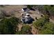 Aerial view of country home with large trees, fencing and outbuildings on acreage at 5570 Bold Springs Rd, Dacula, GA 30019