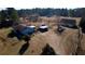 Wide aerial shot featuring a cozy home with sheds, outbuildings, and fenced space at 5570 Bold Springs Rd, Dacula, GA 30019