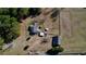 Detailed aerial view of a homestead with a house, barn, and cultivated land at 5570 Bold Springs Rd, Dacula, GA 30019
