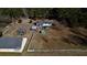 Aerial view of country home showing fencing, outbuildings and wooded back property at 5570 Bold Springs Rd, Dacula, GA 30019