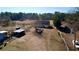 Spacious property showcasing a house, barn, sheds, and fenced area for animals at 5570 Bold Springs Rd, Dacula, GA 30019