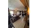 Dining room with tile floor and view into the kitchen, surrounded by plants at 5570 Bold Springs Rd, Dacula, GA 30019