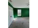 Bedroom features vibrant green walls, a window, and carpet, creating a unique and inviting space at 509 Arnold Road, Lawrenceville, GA 30044