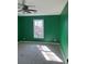 Bedroom featuring green walls, carpet, a ceiling fan, and ample natural light, creating a serene retreat at 509 Arnold Rd, Lawrenceville, GA 30044