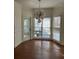 Sunlit breakfast nook with hardwood floors, bay windows, and a modern light fixture at 509 Arnold Road, Lawrenceville, GA 30044