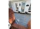 Inviting entrance with a painted wood porch, a storm door, and a brick railing at 509 Arnold Road, Lawrenceville, GA 30044