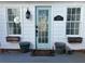 Charming front entrance with a glass paneled door, sidelight windows, and potted plants at 509 Arnold Road, Lawrenceville, GA 30044