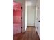 Open hallway view reveals hardwood flooring and a glimpse into a bright room with pink walls at 509 Arnold Rd, Lawrenceville, GA 30044