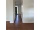 Inviting hallway showcasing gleaming hardwood floors and neutral paint, creating a seamless transition between rooms at 509 Arnold Road, Lawrenceville, GA 30044