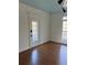 Cozy room featuring hardwood floors, white trim, blue ceiling and a glass door leading to the outside at 509 Arnold Road, Lawrenceville, GA 30044