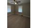 Bedroom with windows, ceiling fan, and light walls at 5157 West St, Covington, GA 30014