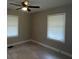 Bedroom featuring window with blinds, ceiling fan, and light-colored walls at 5157 West St, Covington, GA 30014