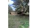 Exterior shot of home featuring mature trees and a partially screened porch at 5157 West St, Covington, GA 30014