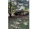 Street view of a cozy home featuring a partially screened porch and mature trees at 5157 West St, Covington, GA 30014