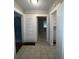 Hallway featuring tile floors and access to different rooms at 5157 West St, Covington, GA 30014