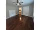 Living room with hardwood floors, decorative fireplace and a ceiling fan at 5157 West St, Covington, GA 30014