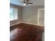 Living room with hardwood floors, ceiling fan and natural light at 5157 West St, Covington, GA 30014