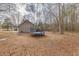 Back exterior of the house with a view of the backyard and wooded area at 5833 Westerling Pl, Powder Springs, GA 30127