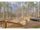 View of a backyard surrounded by trees and containing a trampoline at 5833 Westerling Pl, Powder Springs, GA 30127