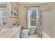 Bathroom featuring a floral shower curtain, and a light beige painting at 5833 Westerling Pl, Powder Springs, GA 30127
