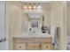 Bathroom vanity with granite countertops, a toilet, and a large mirror at 5833 Westerling Pl, Powder Springs, GA 30127