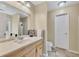 Bright bathroom with a vanity, large mirror, and modern fixtures at 5833 Westerling Pl, Powder Springs, GA 30127