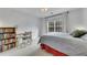 Bright bedroom with a gray bedspread, a desk, a bookcase, and a large window at 5833 Westerling Pl, Powder Springs, GA 30127