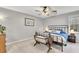 Comfortable bedroom with a bed, a ceiling fan, a window, and neutral decor at 5833 Westerling Pl, Powder Springs, GA 30127