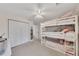 Bedroom with bunk beds, light-colored walls and carpet, and a ceiling fan at 5833 Westerling Pl, Powder Springs, GA 30127