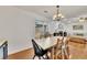 Bright dining room with hardwood floors, an elegant chandelier, and access to the outdoor space at 5833 Westerling Pl, Powder Springs, GA 30127