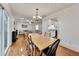 Open concept dining room with beautiful hardwood floors connected to the living area and kitchen at 5833 Westerling Pl, Powder Springs, GA 30127