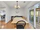 Bright dining area with modern chandelier and large sliding glass doors at 5833 Westerling Pl, Powder Springs, GA 30127