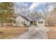 Ranch-style home featuring a two-car garage and concrete driveway at 5833 Westerling Pl, Powder Springs, GA 30127