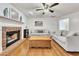 Bright living room with a brick fireplace, hardwood floors, and ample seating at 5833 Westerling Pl, Powder Springs, GA 30127