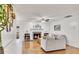 Cozy living room with a brick fireplace, hardwood floors, and bright white walls at 5833 Westerling Pl, Powder Springs, GA 30127