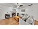 Inviting living room featuring a brick fireplace, hardwood floors, and comfortable seating at 5833 Westerling Pl, Powder Springs, GA 30127