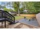 A quaint backyard featuring a stone fire pit area, bordered by a wooden fence and lush greenery, perfect for entertaining at 645 Cumberland Rd, Atlanta, GA 30306