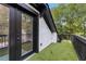 Balcony with black trim features artificial turf and view of mature trees at 645 Cumberland Rd, Atlanta, GA 30306