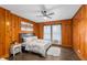 Bedroom featuring wood paneling, white bedding, with a view from the windows at 645 Cumberland Rd, Atlanta, GA 30306