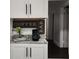 Coffee bar with granite countertops, and sleek white cabinets, adjacent to the doorway at 645 Cumberland Rd, Atlanta, GA 30306