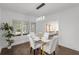 Dining room with seating for four, modern chandelier, and a view into the brightly lit living room at 645 Cumberland Rd, Atlanta, GA 30306