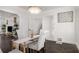 Well-lit dining room features a glass table, tufted chairs, and decorative chandelier at 645 Cumberland Rd, Atlanta, GA 30306