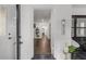 Welcoming entryway with wood floors, a white brick wall, and views of a bright living area at 645 Cumberland Rd, Atlanta, GA 30306