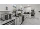 Modern kitchen with stainless steel appliances, granite countertops, and bright white cabinets at 645 Cumberland Rd, Atlanta, GA 30306