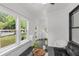 Bright sunroom with black marble floors and lots of windows looking out onto the yard at 645 Cumberland Rd, Atlanta, GA 30306